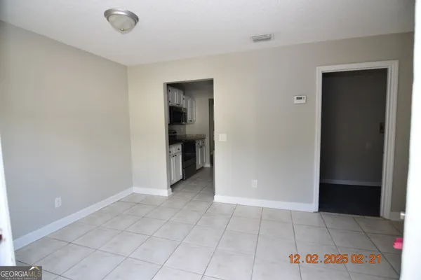 an empty room with closet and mirrors