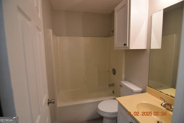 a bathroom with a toilet a sink and bathtub