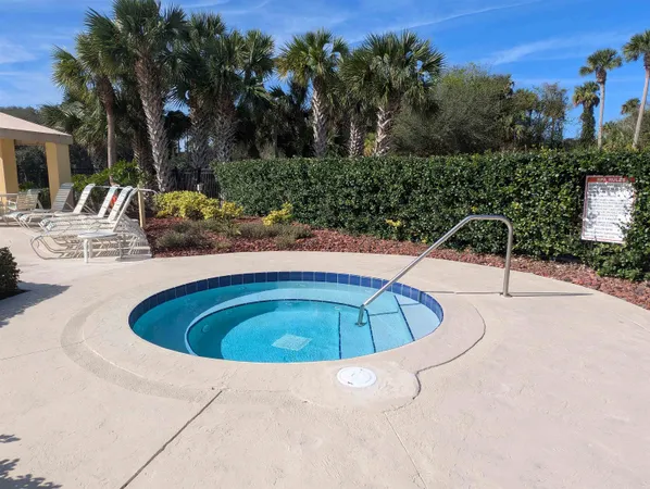 a swimming pool with outdoor seating and yard