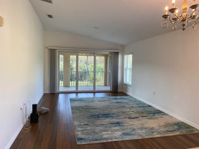 a view of a room with wooden floor and a window