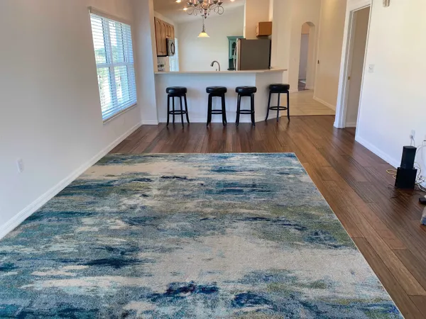 a view of livingroom and dining room with wooden floor