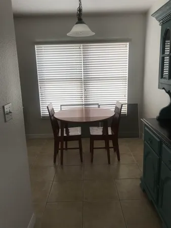 a view of a dining room with furniture and window