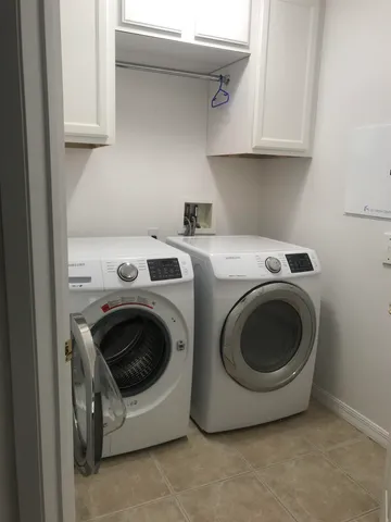a utility room with sink dryer and washer