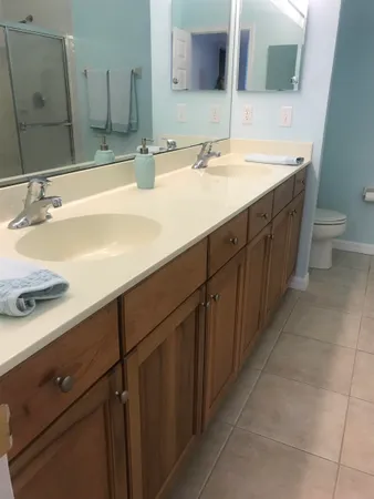 a bathroom with a double vanity sink and a mirror