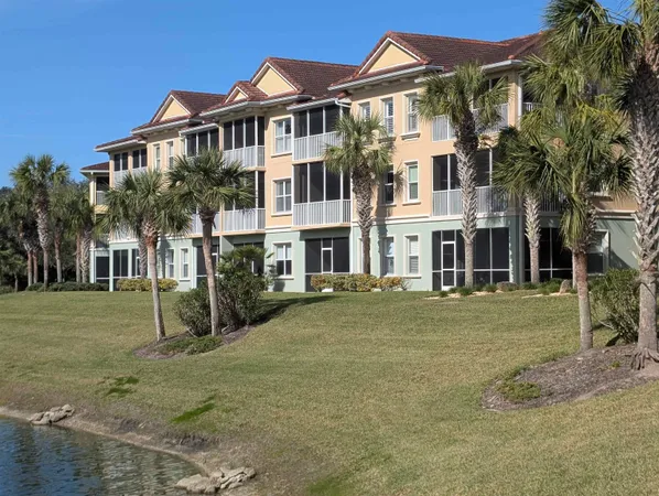 a front view of a residential apartment building with a yard