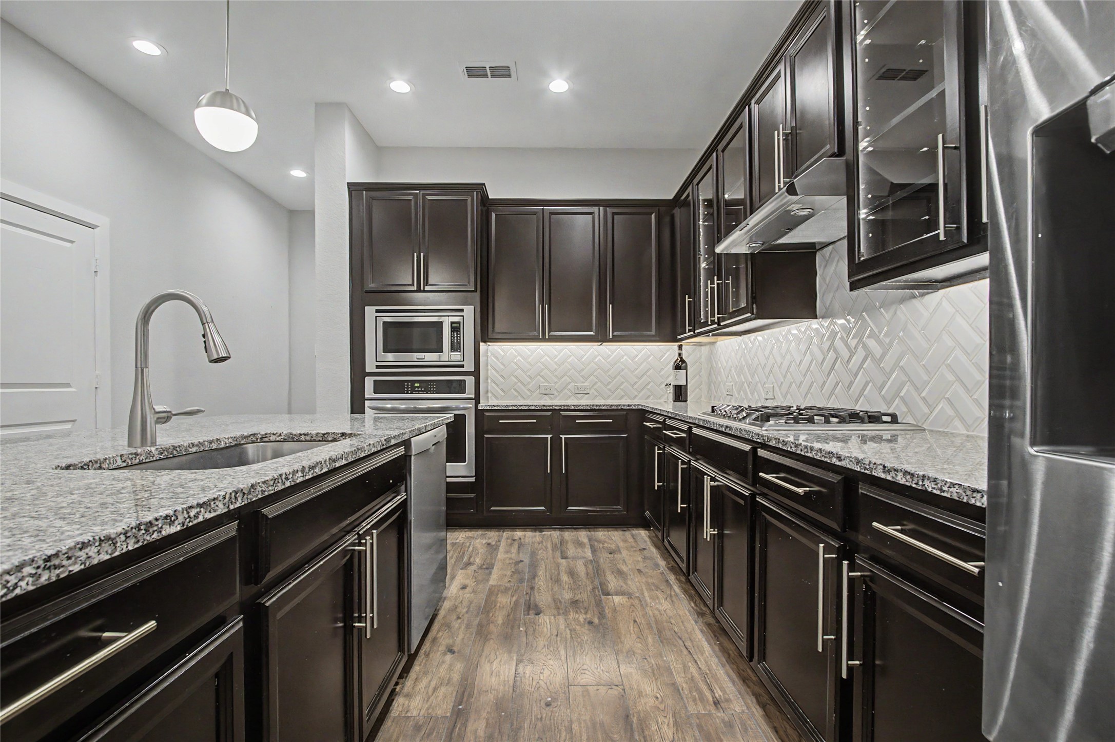 19718 Shinnery Ridge Court Cypress, TX 77433 - Photo 5 of 23 a kitchen with stainless steel appliances granite countertop a stove a sink and a refrigerator