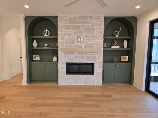 a kitchen with a stove a counter space a sink and a window