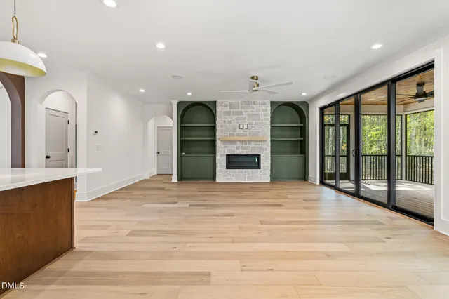 a kitchen with a stove a counter space a sink and a window