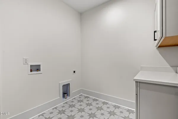 a view of room with wooden floor and entryway