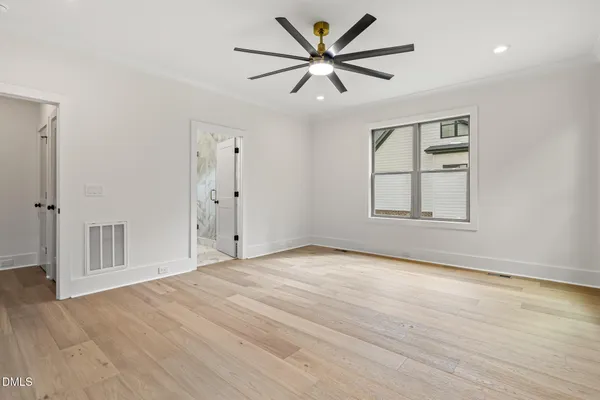 a view of a room with wooden floor and floor to ceiling window