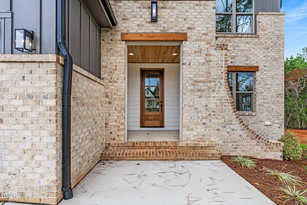 a large kitchen with stainless steel appliances kitchen island a large counter top and a wooden floors
