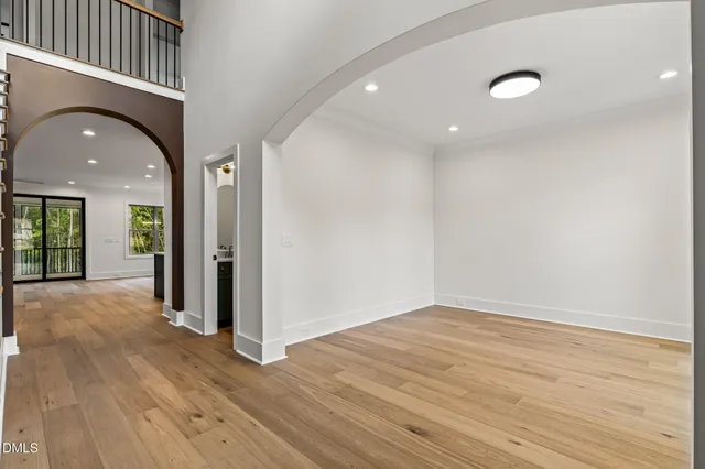 a large kitchen with stainless steel appliances kitchen island a large counter top and a wooden floors