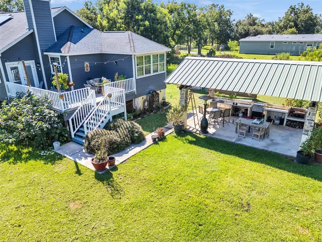 a front view of a house with swimming pool patio and outdoor seating