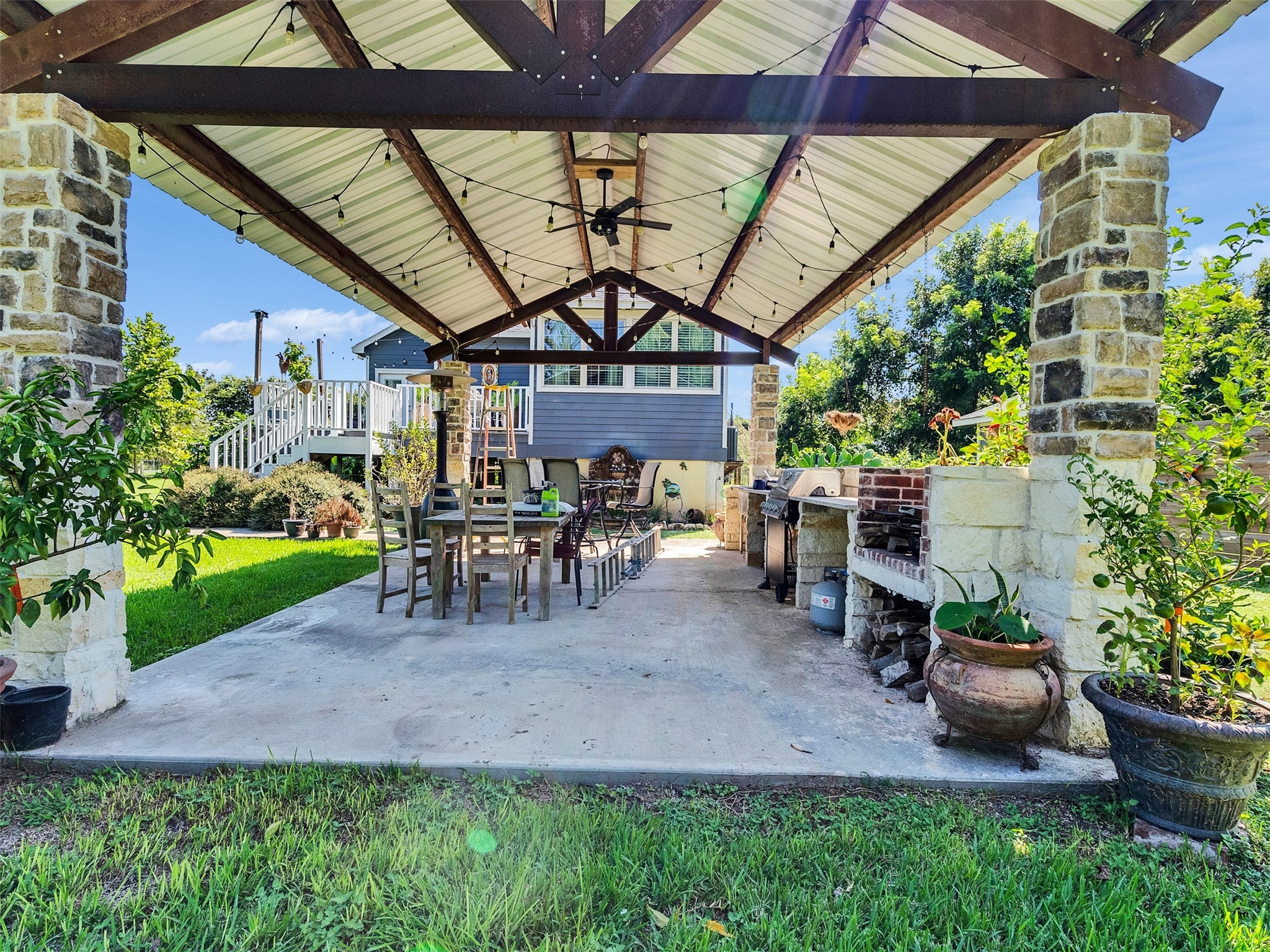 625 Pittman Road Richmond, TX 77469 - Photo 26 of 29 a view of a patio with table and chairs potted plants and a palm tree