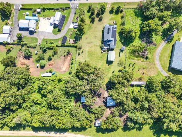 an aerial view of residential house with outdoor space and swimming pool