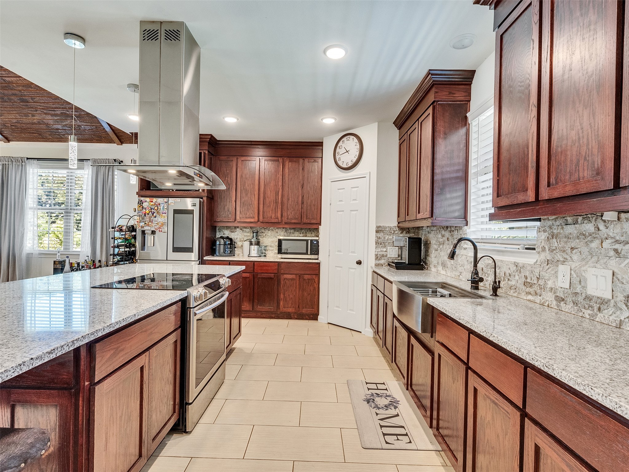 625 Pittman Road Richmond, TX 77469 - Photo 4 of 29 a large kitchen with stainless steel appliances granite countertop a sink wooden cabinets and a refrigerator