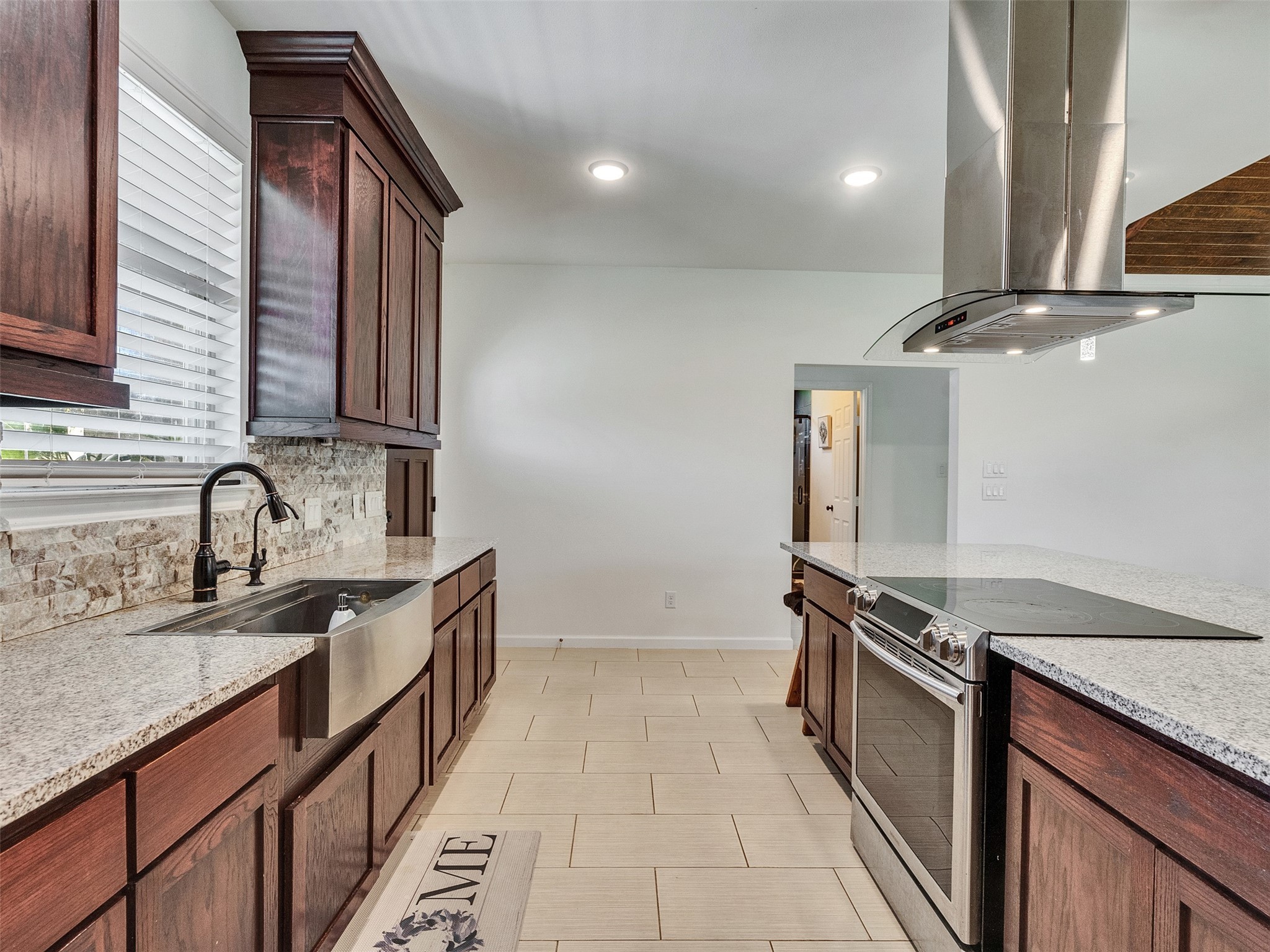 625 Pittman Road Richmond, TX 77469 - Photo 6 of 29 a kitchen with granite countertop a sink stove and cabinets