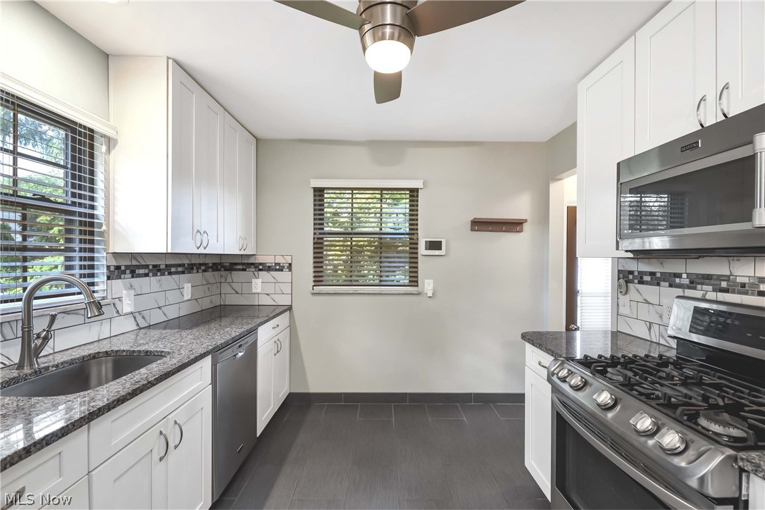 21483 Eaton Road Cleveland, OH 44126 - Photo 11 of 25 Kitchen with sink, a healthy amount of sunlight, tasteful backsplash, and appliances with stainless steel finishes
