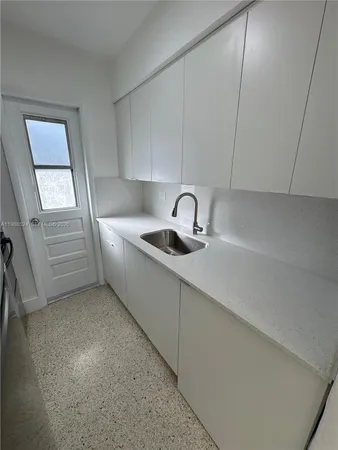 a kitchen with a sink and washing machine