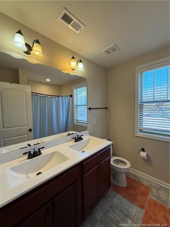 22 Raintree Lane Spring Lake, NC 28390 - Photo 13 of 25 a bathroom with a sink double vanity granite and a toilet