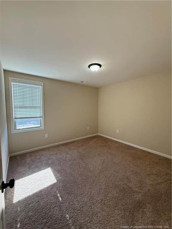 22 Raintree Lane Spring Lake, NC 28390 - Photo 16 of 25 an empty room with a empty space and windows