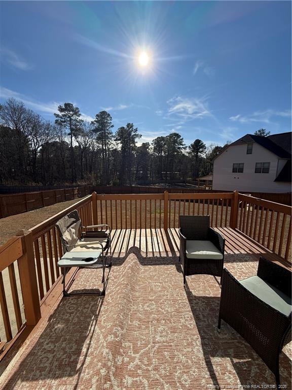 22 Raintree Lane Spring Lake, NC 28390 - Photo 23 of 25 a view of a roof deck with couches and wooden floor