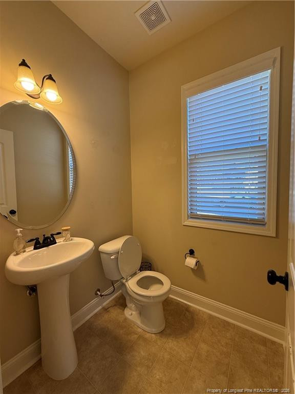 22 Raintree Lane Spring Lake, NC 28390 - Photo 10 of 25 a bathroom with a toilet sink and mirror