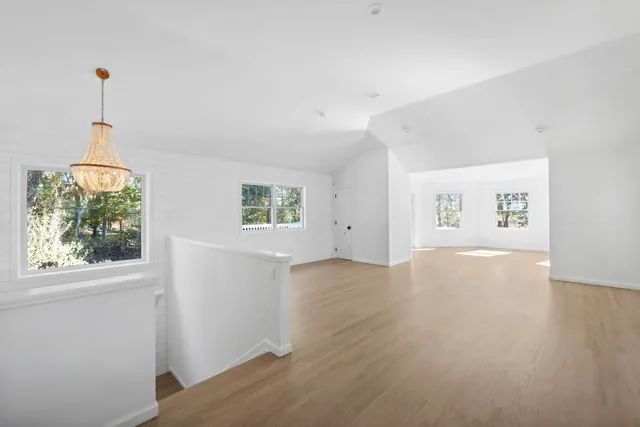a kitchen with a sink cabinets stainless steel appliances and a window