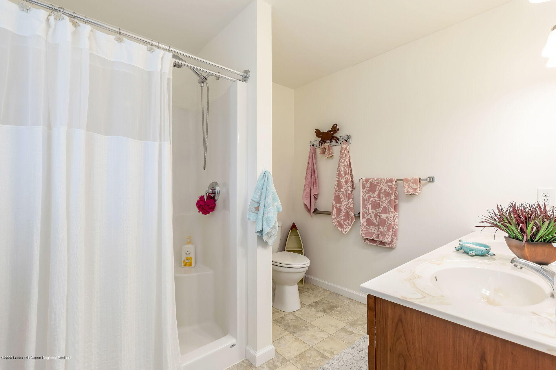 139 Flamingo Road Tuckerton, NJ 08087 - Photo 12 of 22 a bathroom with a sink a toilet and shower curtain