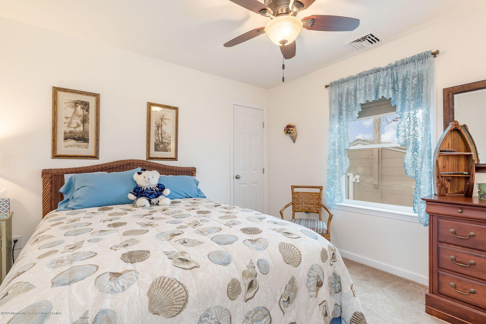 139 Flamingo Road Tuckerton, NJ 08087 - Photo 9 of 22 a bedroom with a large bed and a chandelier