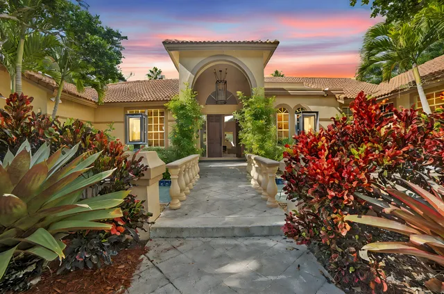 a front view of a house with a garden