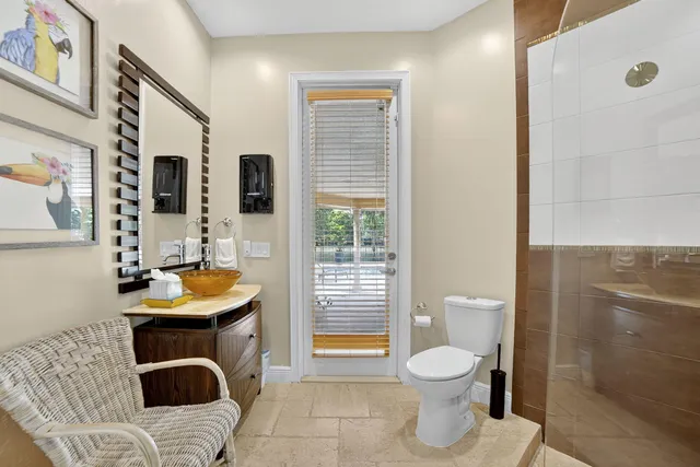 a spacious bedroom with a bed a couch and a chandelier