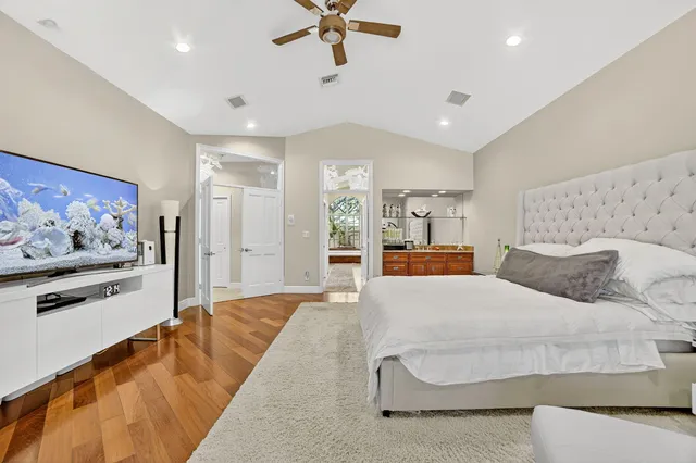 a spacious bedroom with a bed and a dresser