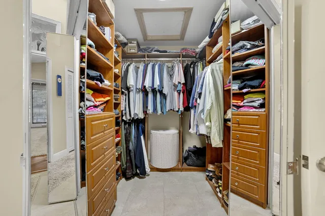 a dining room with furniture and large windows