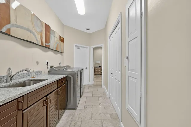 a bathroom with a granite countertop toilet sink and mirror