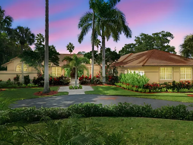 a backyard of a house with a garden and outdoor seating