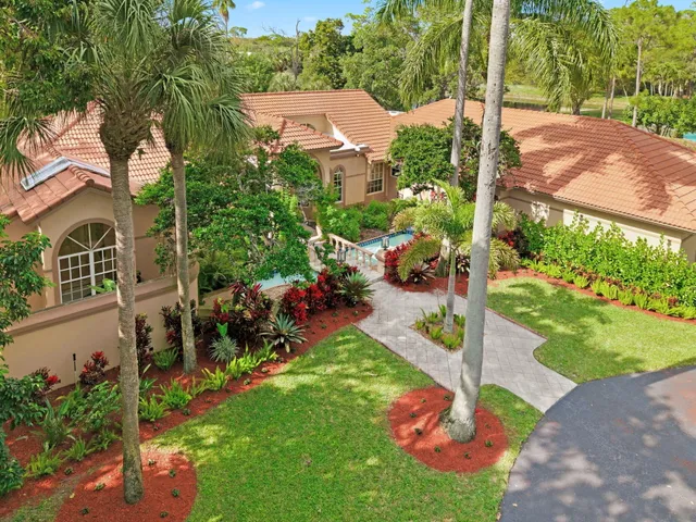 a aerial view of a house with a yard table and chairs