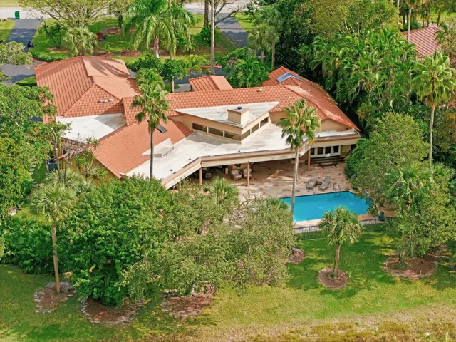 an aerial view of lake and residential houses with outdoor space