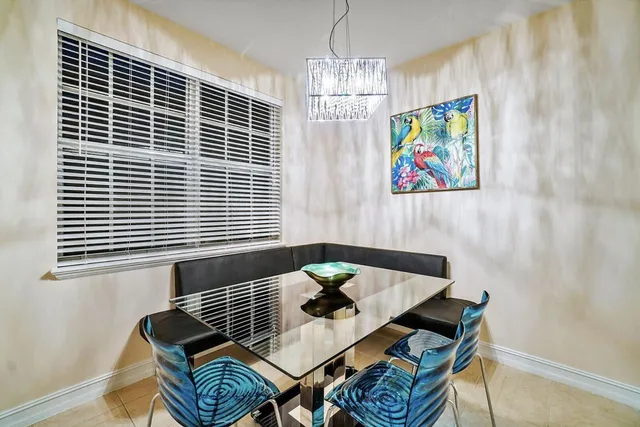 a view of a dining room with furniture and chandelier