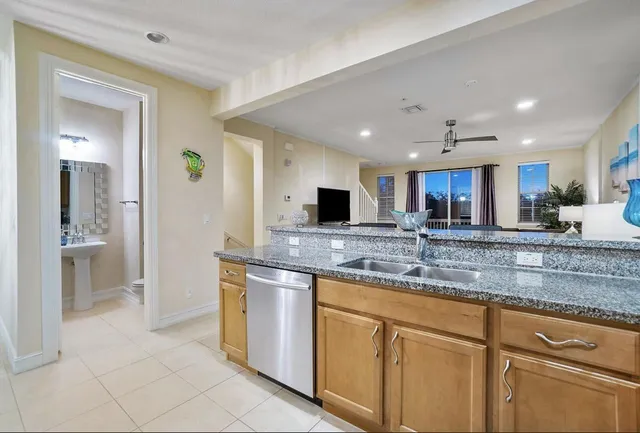 a kitchen with stainless steel appliances granite countertop a sink and a stove