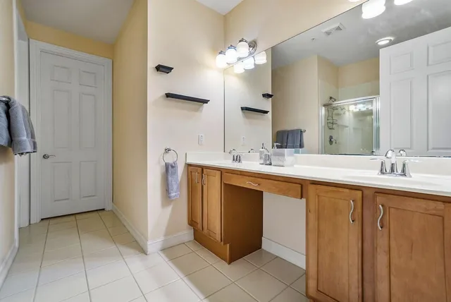 a spacious bathroom with a sink a mirror and a shower