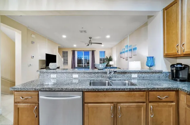 a kitchen with granite countertop a sink and a stove