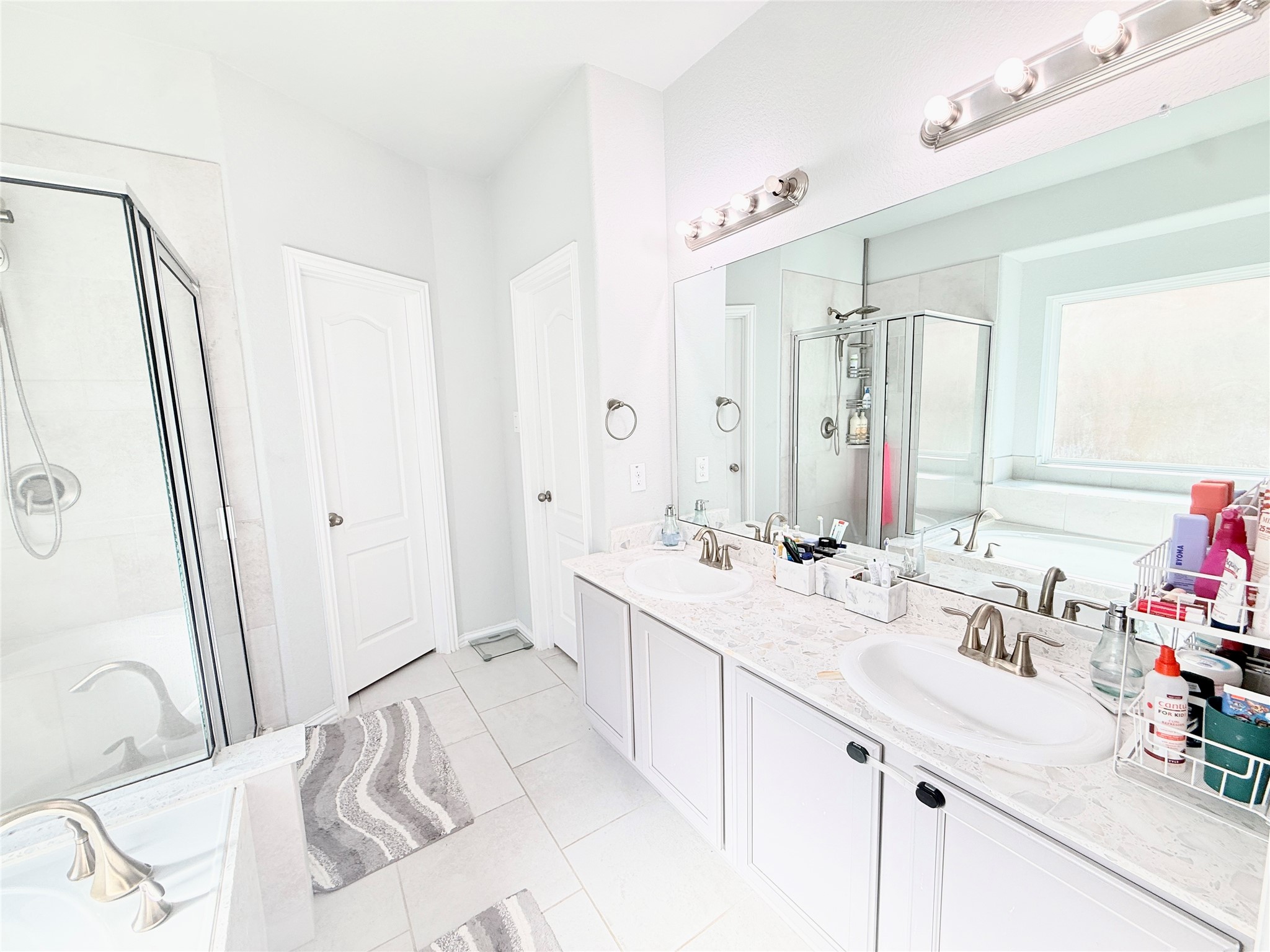 104 Kelly Street Angleton, TX 77515 - Photo 9 of 20 a bathroom with a sink double vanity mirror and a