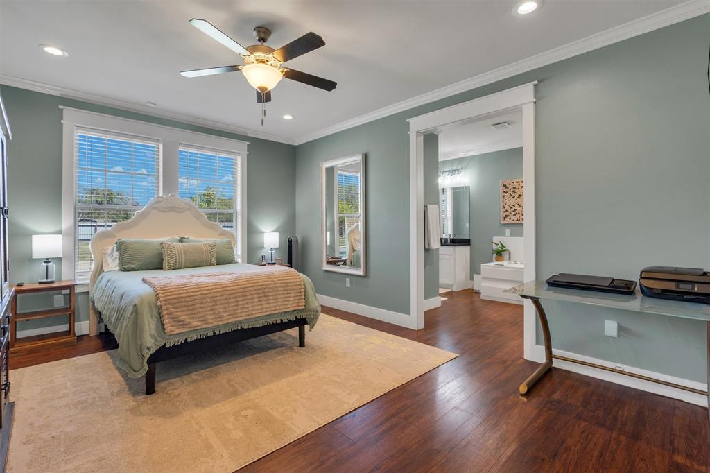 300 West Bell Street Everman, TX 76140 - Photo 11 of 28 a bedroom with a bed and a chandelier