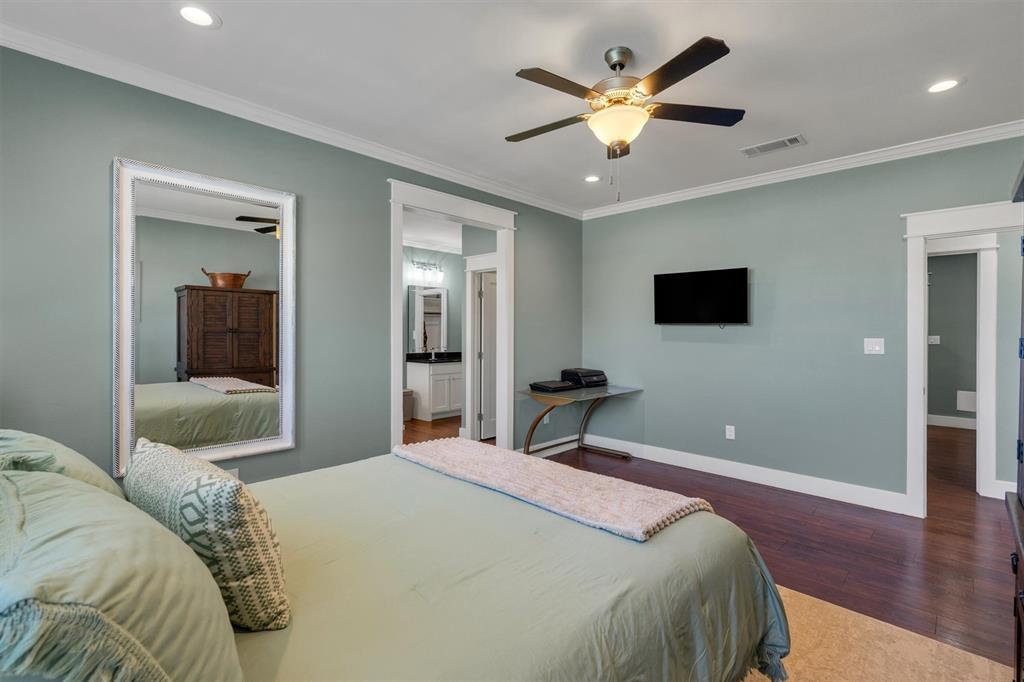 300 West Bell Street Everman, TX 76140 - Photo 12 of 28 a bedroom with a bed and a flat screen tv