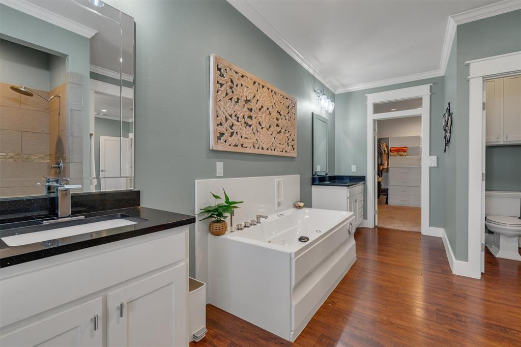 300 West Bell Street Everman, TX 76140 - Photo 15 of 28 a en suite bathroom with a double vanity sink and a mirror