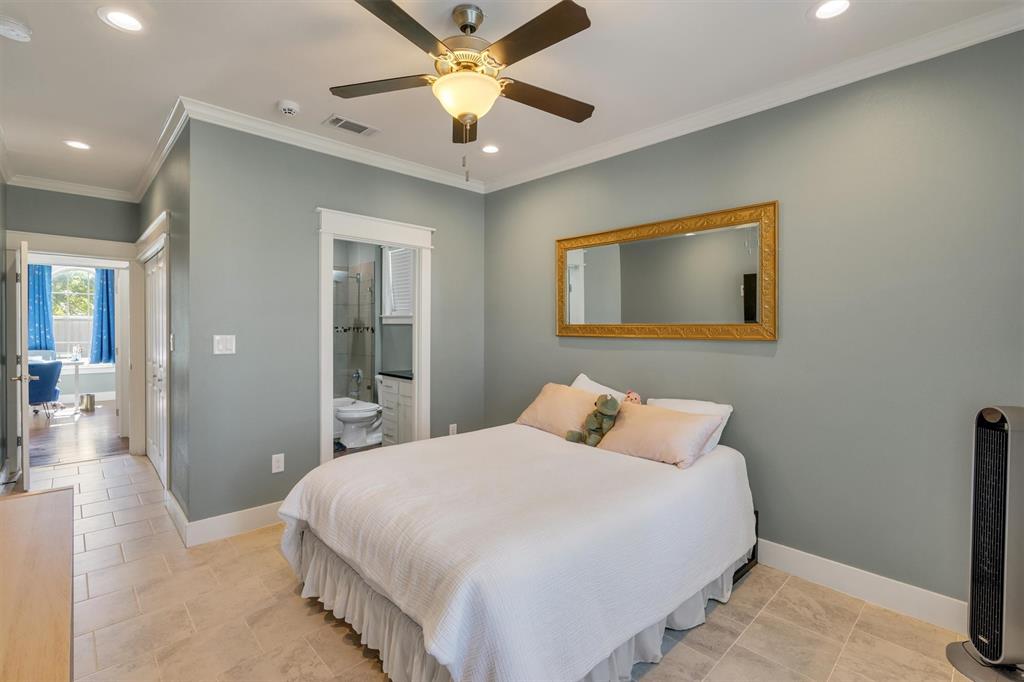300 West Bell Street Everman, TX 76140 - Photo 22 of 28 a bedroom with a large bed and a chandelier