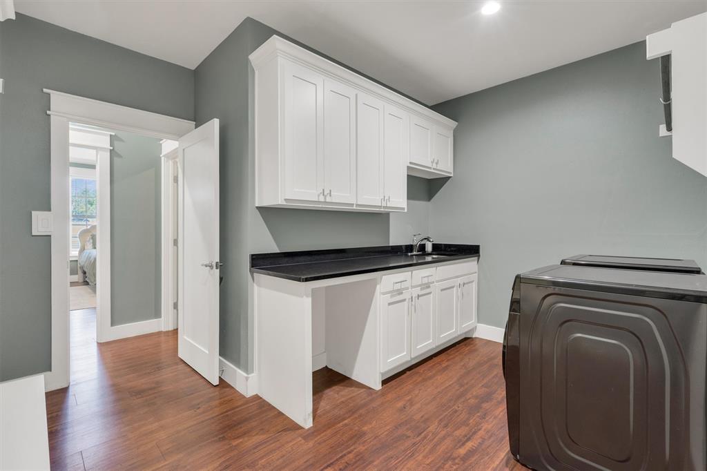 300 West Bell Street Everman, TX 76140 - Photo 24 of 28 a kitchen with a refrigerator and a stove top oven