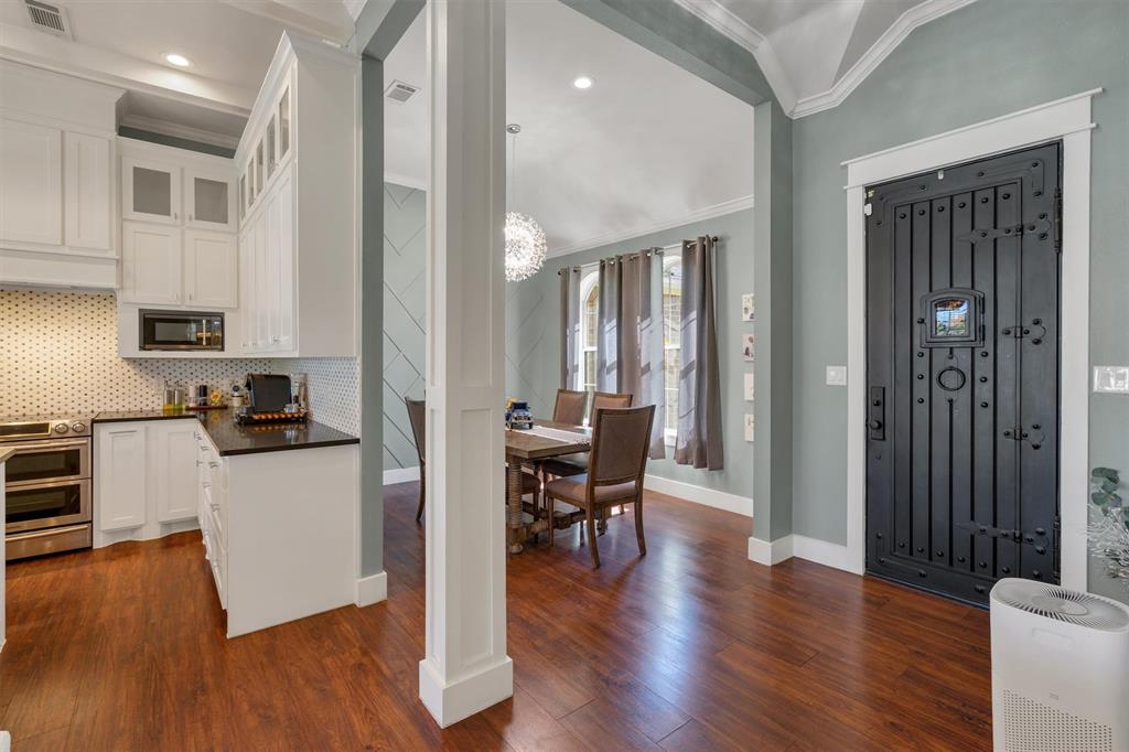 300 West Bell Street Everman, TX 76140 - Photo 3 of 28 a kitchen with a table chairs refrigerator and cabinets