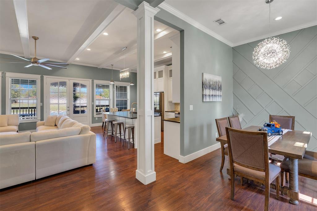 300 West Bell Street Everman, TX 76140 - Photo 4 of 28 a living room with furniture a dining table wooden floor and a fireplace